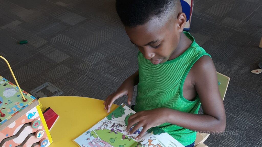 Young Black Boy Reading A Book