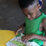 Young Black Boy Reading A Book