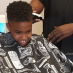 Handsome Black Boy Getting A Haircut