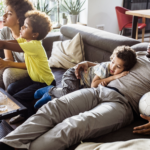 Black Family Enjoying Television On Couch